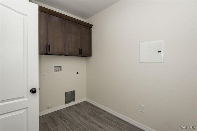 clothes washing area with hookup for a gas dryer, hookup for an electric dryer, washer hookup, baseboards, and cabinet space