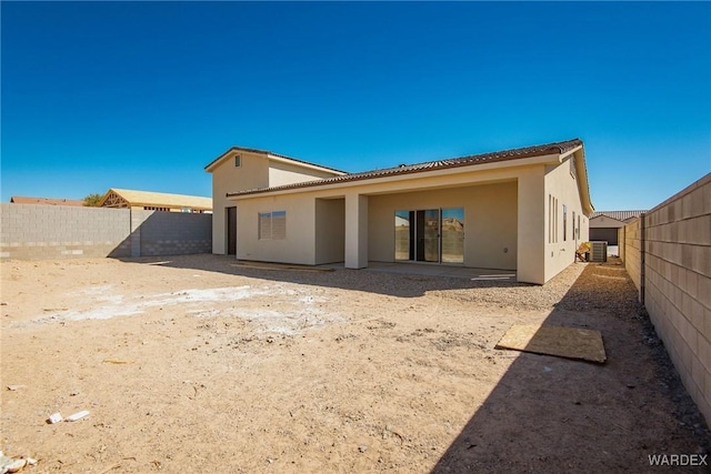 back of property featuring a patio area, a fenced backyard, central AC unit, and stucco siding