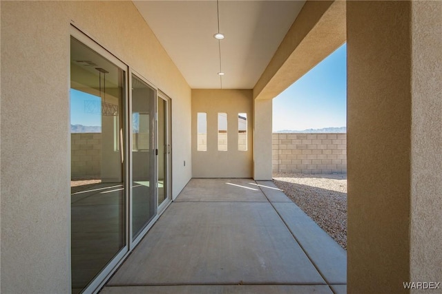 view of patio featuring fence