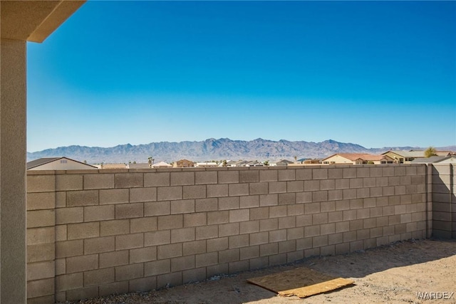 view of yard with fence and a mountain view