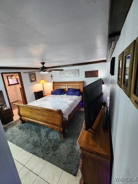10626 Fenton Dr, Parker, AZ 85344 - bedroom featuring ceiling fan, a textured ceiling, and light tile patterned floors