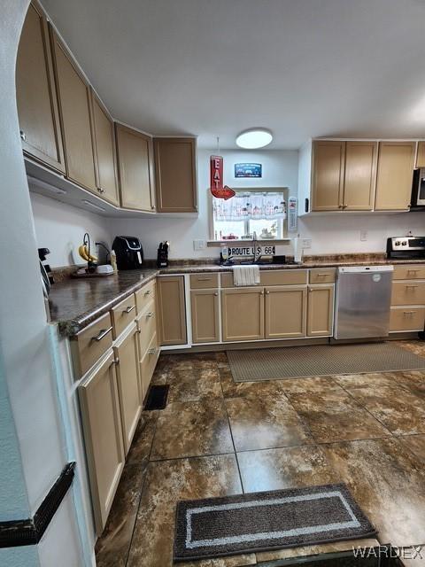 10626 Fenton Dr, Parker, AZ 85344 - kitchen featuring dark countertops, stone finish floor, stainless steel appliances, and a sink