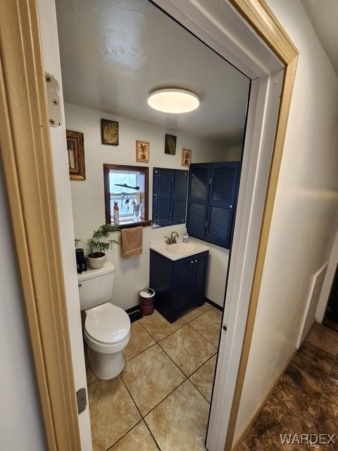 10626 Fenton Dr, Parker, AZ 85344 - half bathroom with tile patterned floors, vanity, and toilet