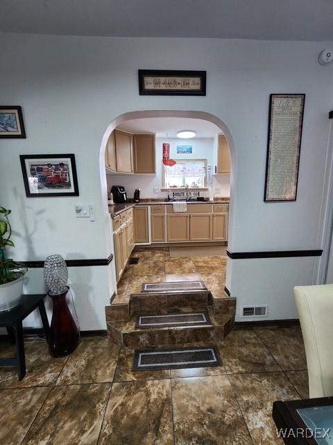 10626 Fenton Dr, Parker, AZ 85344 - corridor with arched walkways, stone finish floor, a sink, and visible vents