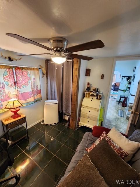 10626 Fenton Dr, Parker, AZ 85344 - bedroom featuring ceiling fan, baseboards, and dark tile patterned floors