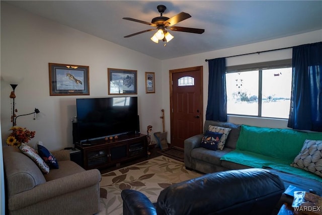 living area featuring vaulted ceiling and a ceiling fan