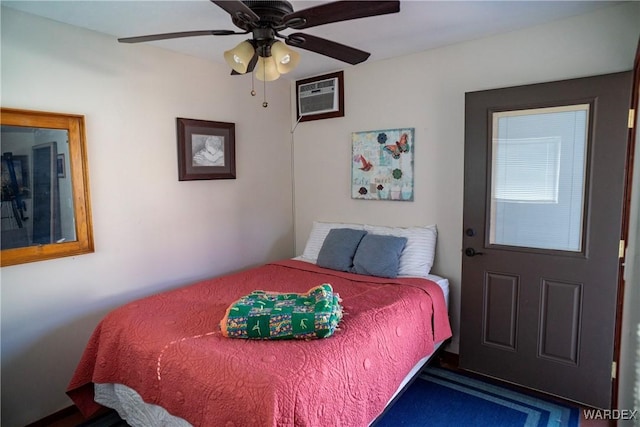 bedroom with ceiling fan and a wall mounted AC