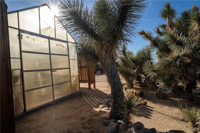 view of yard with a greenhouse and an outdoor structure