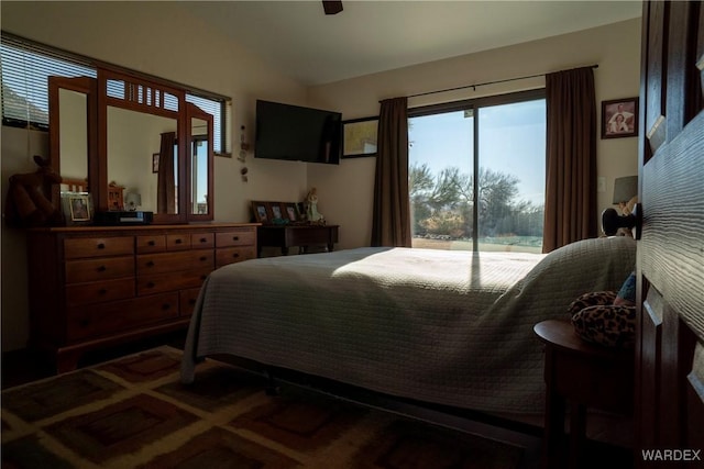 bedroom featuring lofted ceiling, access to outside, and carpet flooring