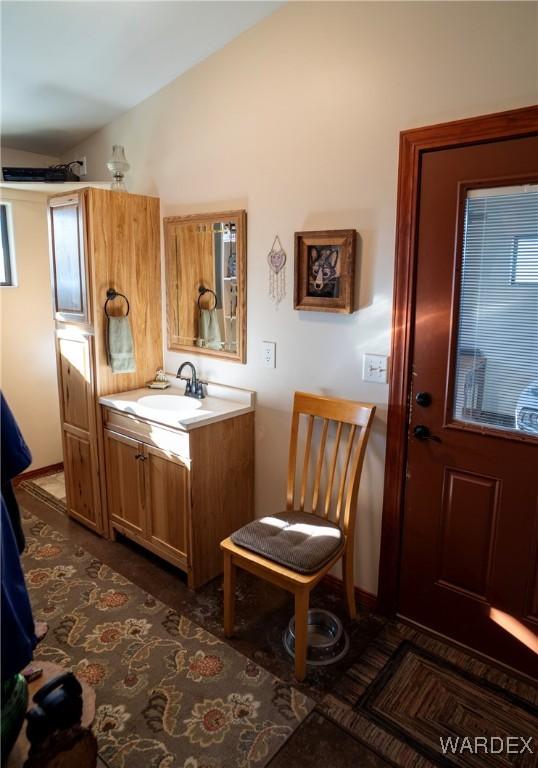 bathroom with vaulted ceiling and vanity