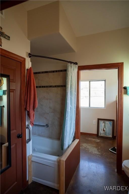 bathroom with concrete flooring, shower / tub combo, and toilet