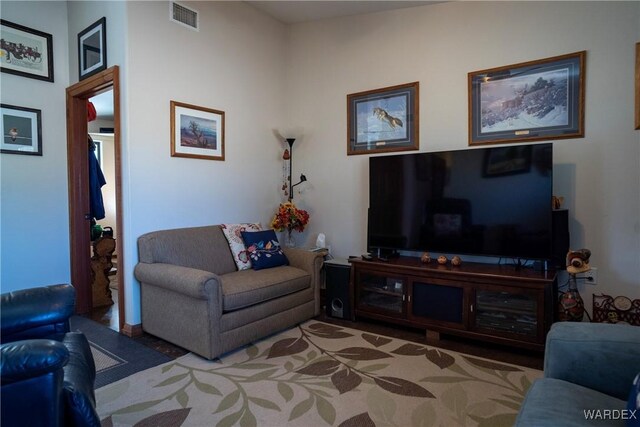 living room with visible vents and light carpet