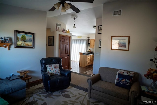 living room with lofted ceiling, carpet, visible vents, and a ceiling fan