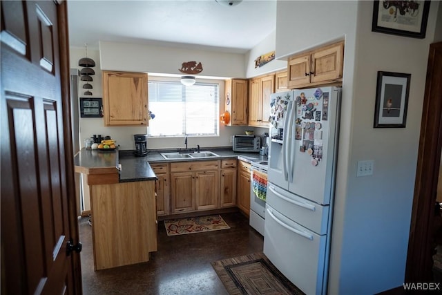 kitchen with white appliances, a toaster, dark countertops, a kitchen island, and a sink