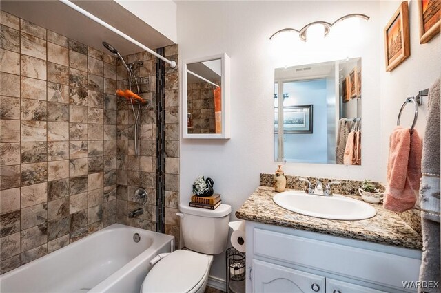 bathroom with toilet, bathing tub / shower combination, and vanity