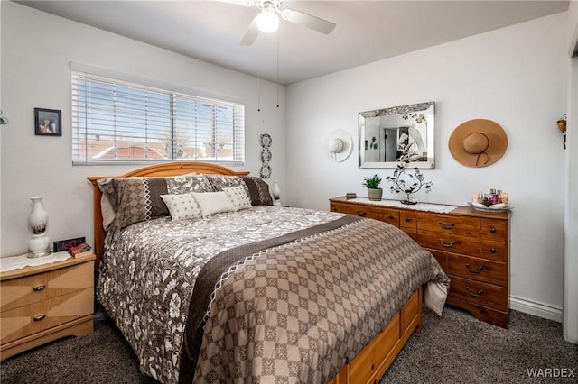 bedroom with dark carpet and a ceiling fan