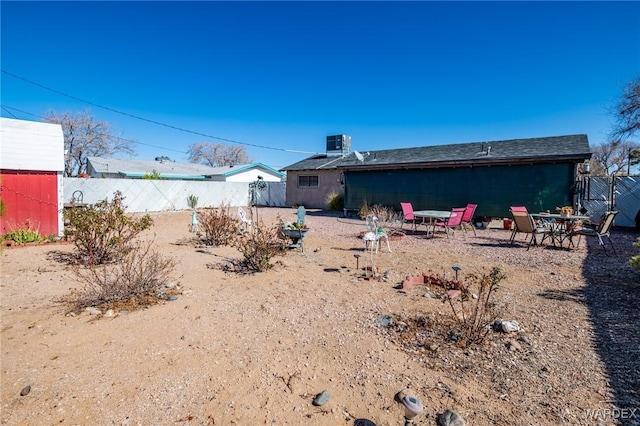 rear view of property with fence and cooling unit