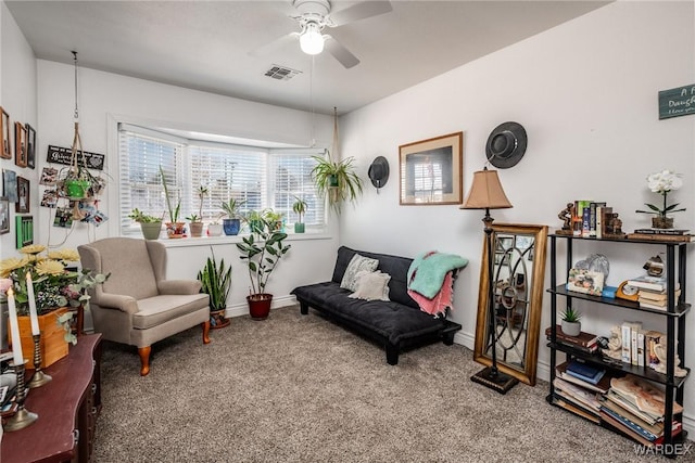 living area with ceiling fan, carpet, visible vents, and baseboards