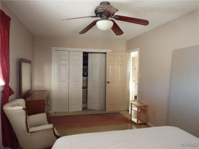 bedroom with a ceiling fan, a closet, and wood finished floors