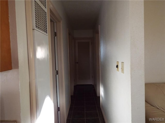 corridor featuring dark tile patterned flooring