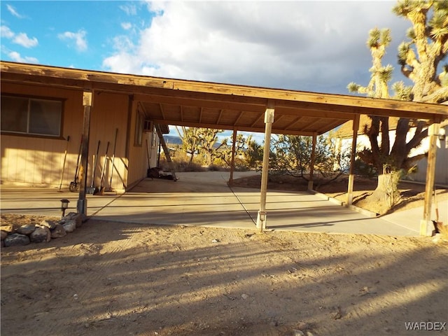 surrounding community featuring an attached carport