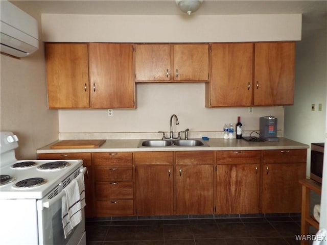 kitchen featuring white electric stove, light countertops, a sink, and a wall mounted air conditioner