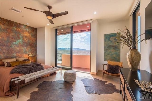 bedroom featuring a mountain view, recessed lighting, visible vents, access to exterior, and light wood-type flooring