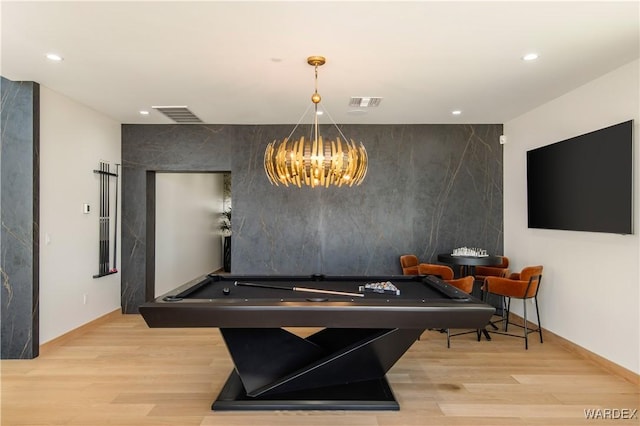 dining room featuring an accent wall, light wood-type flooring, visible vents, and billiards