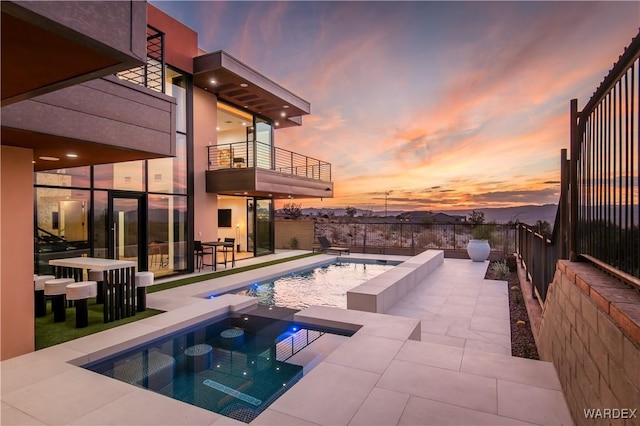 view of swimming pool with a fenced in pool, a fenced backyard, a patio, and an in ground hot tub