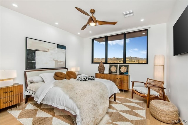 bedroom featuring light wood finished floors, ceiling fan, visible vents, and recessed lighting