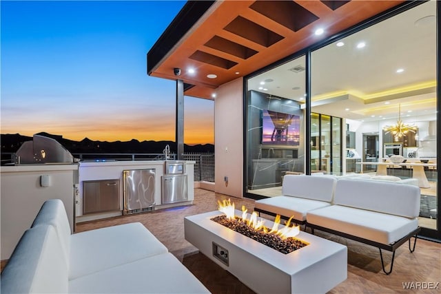 view of patio / terrace featuring an outdoor living space with a fire pit and area for grilling