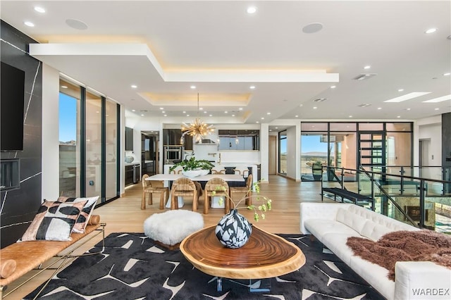 interior space with light wood-type flooring, floor to ceiling windows, and recessed lighting