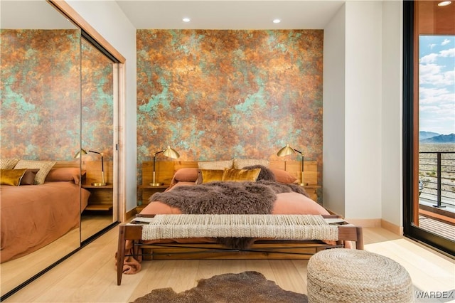 bedroom with light wood-style floors, recessed lighting, access to outside, and baseboards