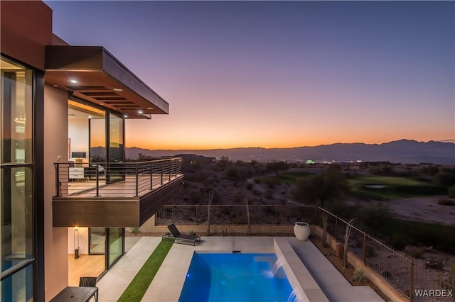 view of swimming pool featuring a patio and a mountain view