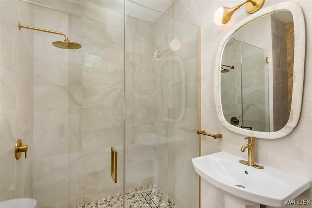 bathroom featuring a sink and a shower stall