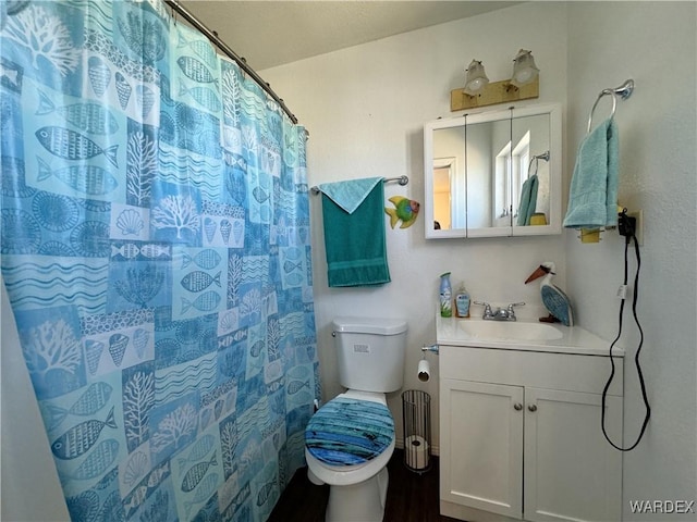 full bathroom with toilet, curtained shower, and vanity