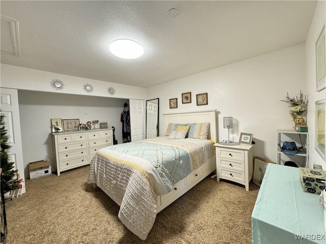 bedroom featuring a textured ceiling and carpet flooring