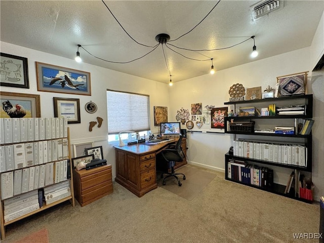 office area with light carpet, a textured ceiling, and visible vents