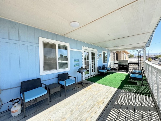 wooden terrace with a lawn, an outdoor living space, area for grilling, and french doors