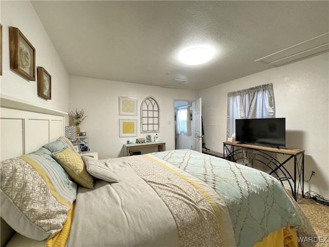 bedroom featuring carpet flooring and a textured ceiling