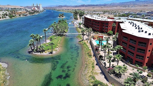 drone / aerial view featuring a water and mountain view