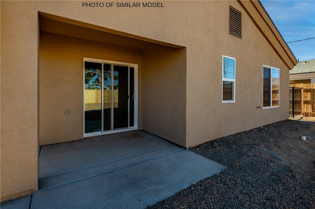 back of house featuring a patio, stucco siding, and fence