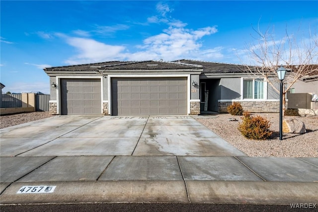 ranch-style house featuring a garage, stone siding, concrete driveway, and stucco siding