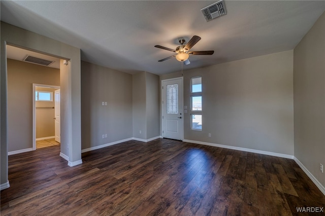 interior space featuring dark wood-style floors, visible vents, and baseboards