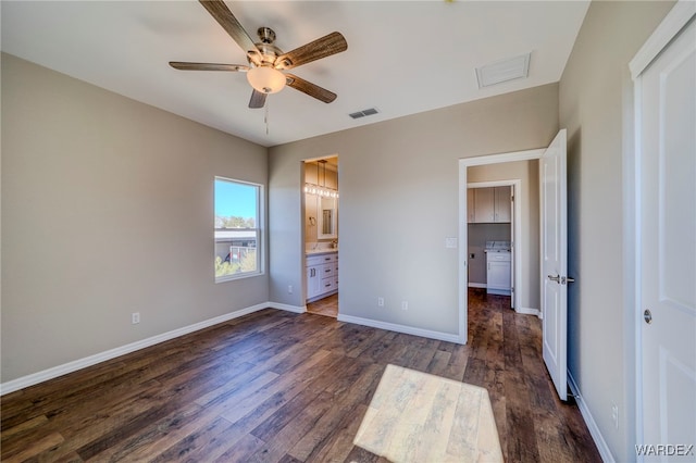 unfurnished bedroom featuring dark wood-style flooring, visible vents, baseboards, and ensuite bathroom