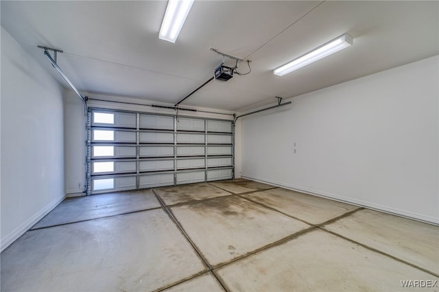 garage featuring baseboards and a garage door opener