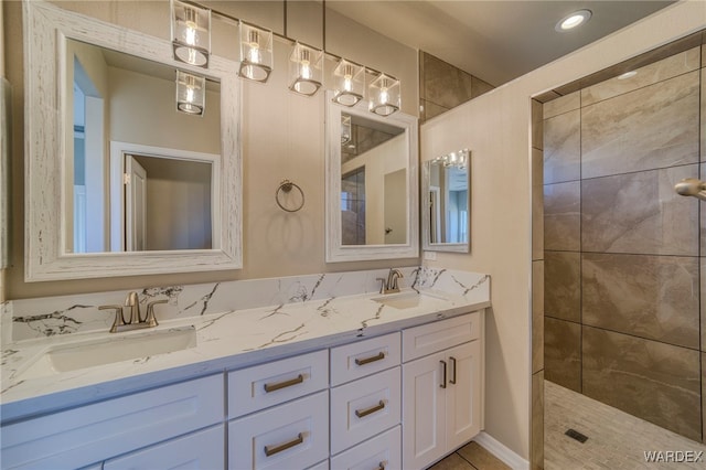 full bathroom featuring a walk in shower, double vanity, and a sink