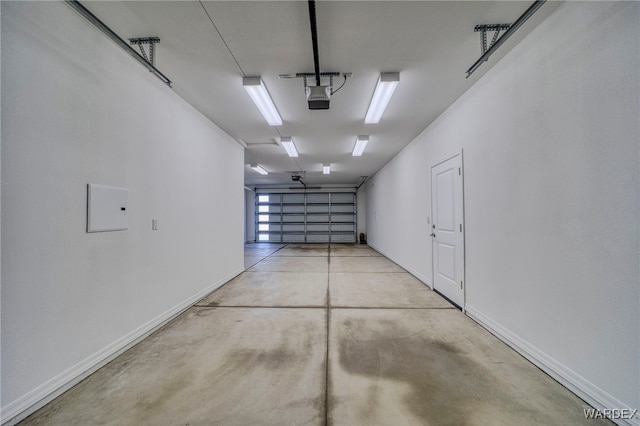 garage with baseboards and a garage door opener