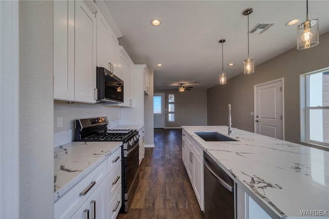 kitchen featuring pendant lighting, visible vents, appliances with stainless steel finishes, white cabinetry, and a sink