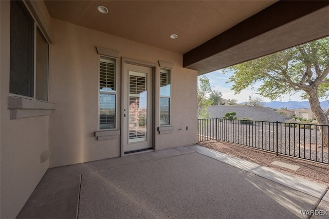 view of patio with fence and a mountain view